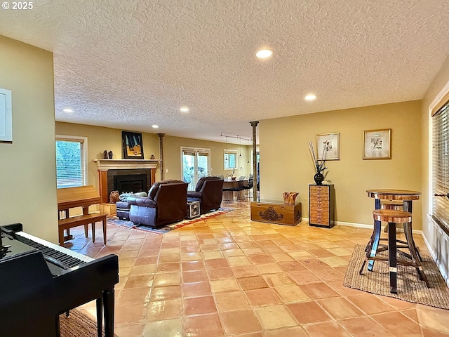 living area featuring light tile patterned floors, recessed lighting, a fireplace, and baseboards