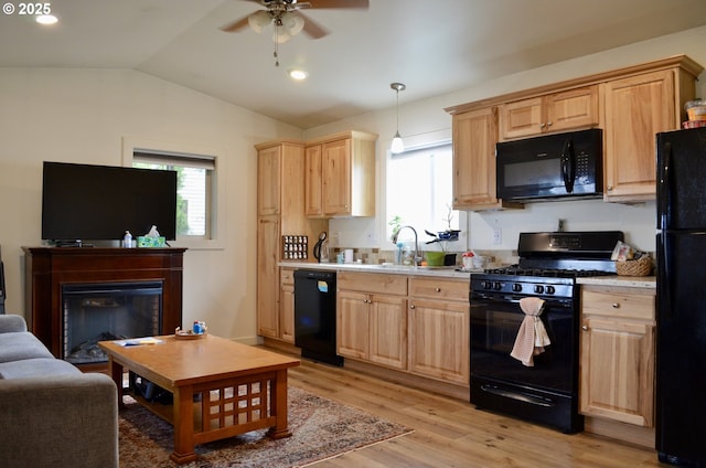 kitchen featuring black appliances, light wood-style flooring, light brown cabinetry, and light countertops