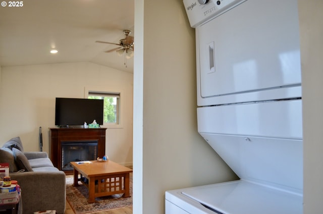 washroom featuring laundry area, recessed lighting, a fireplace, ceiling fan, and stacked washer and dryer