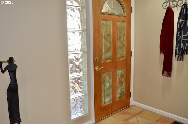 entryway featuring baseboards