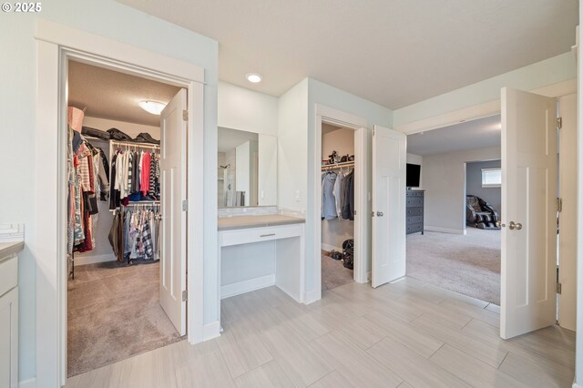4744 S 19th St, Ridgefield, WA 98642 - unfurnished bedroom with a walk in closet, a closet, light carpet, baseboards, and ensuite bath