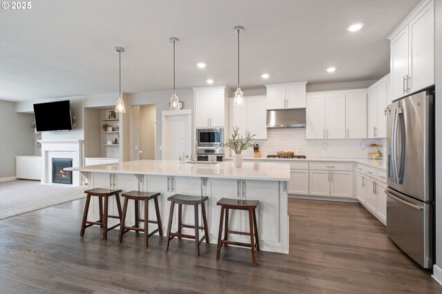 4744 S 19th St, Ridgefield, WA 98642 - kitchen with stainless steel appliances, under cabinet range hood, white cabinets, open floor plan, and recessed lighting