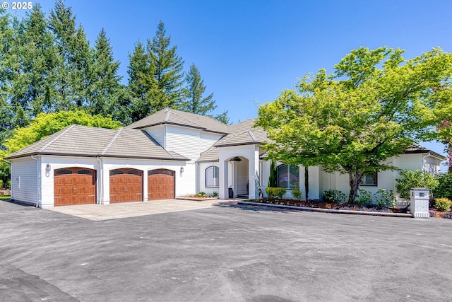 21321 SW Old Kruger Rd, Sherwood, OR 97140 - view of front of home with an attached garage, a tiled roof, and driveway