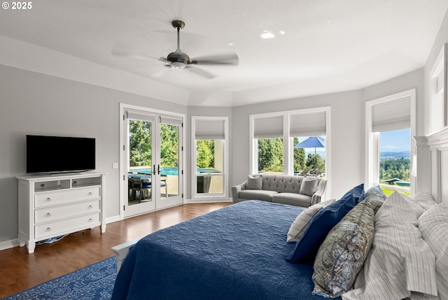 bedroom featuring baseboards, a ceiling fan, wood finished floors, and access to exterior