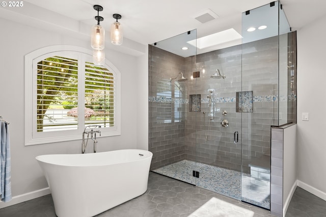 bathroom with tile patterned flooring, a freestanding tub, baseboards, recessed lighting, and a shower stall