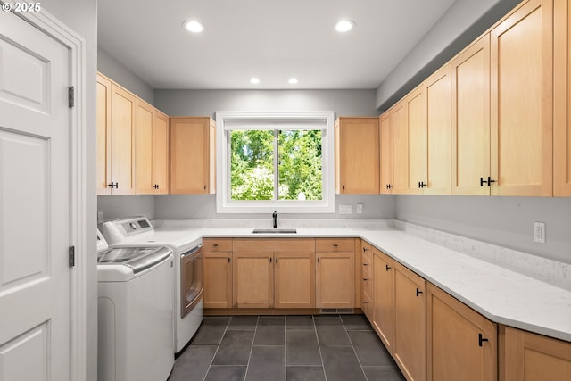washroom featuring independent washer and dryer, cabinet space, a sink, dark tile patterned flooring, and recessed lighting