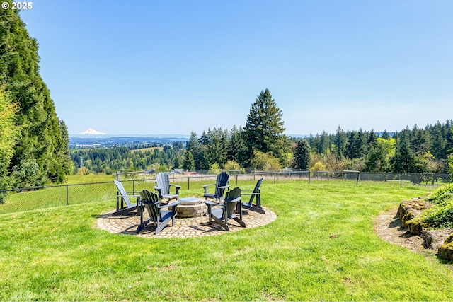 view of yard featuring fence and a fire pit