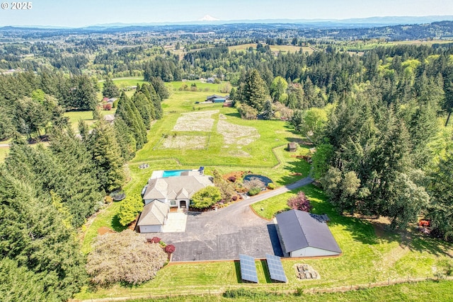 birds eye view of property featuring a view of trees