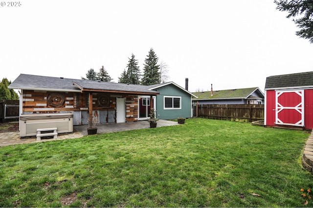 back of house with a lawn, a shed, a patio, and a hot tub