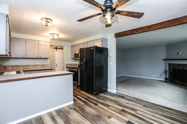 kitchen with gray cabinets, kitchen peninsula, sink, and appliances with stainless steel finishes