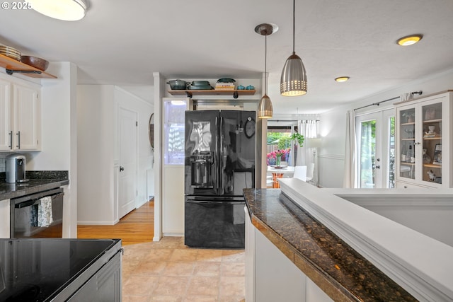 kitchen with white cabinetry, decorative light fixtures, tile countertops, glass insert cabinets, and black appliances