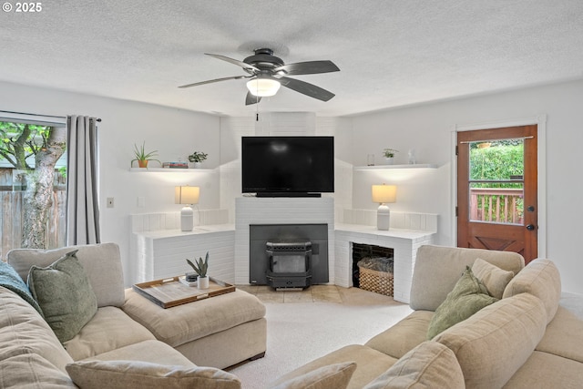 living area featuring a textured ceiling and ceiling fan