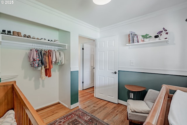 bedroom featuring crown molding, baseboards, and light wood-style flooring