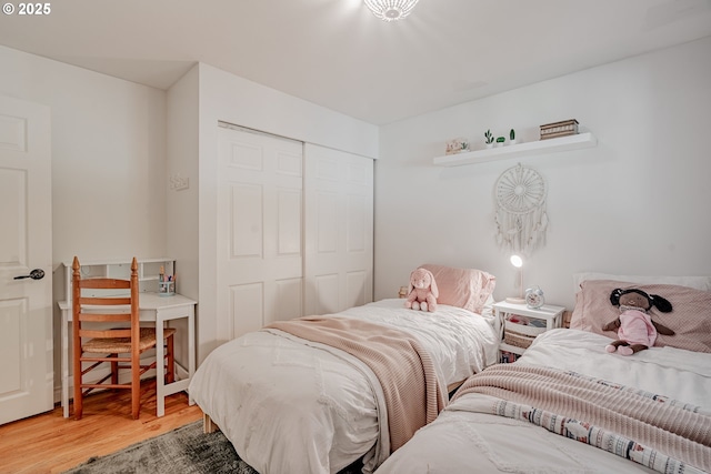 bedroom featuring wood finished floors and a closet