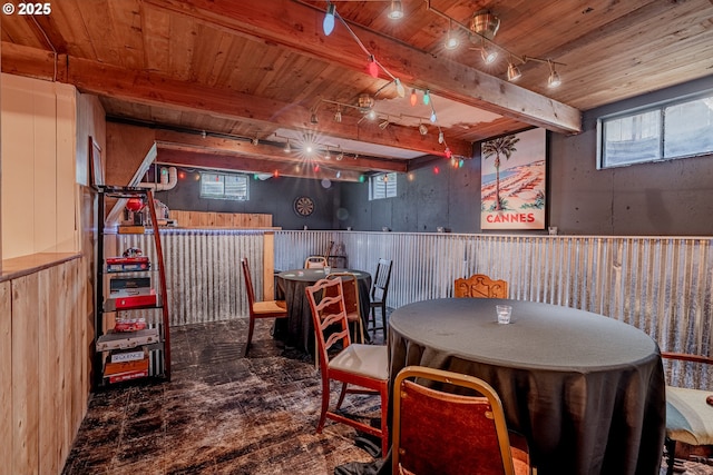 dining room featuring wood walls and wooden ceiling