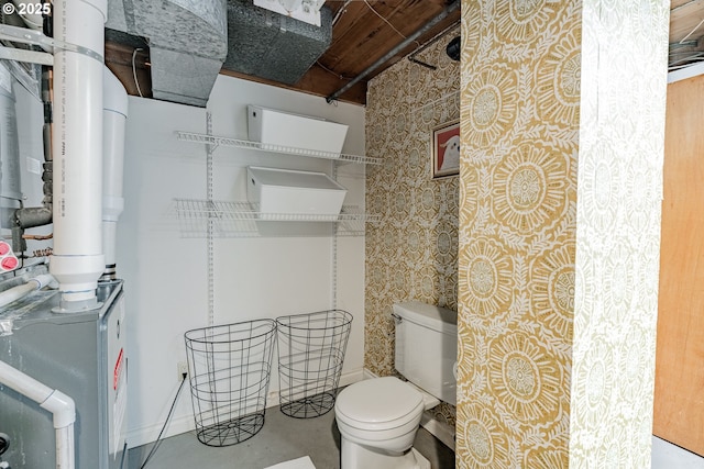 bathroom with concrete flooring and toilet