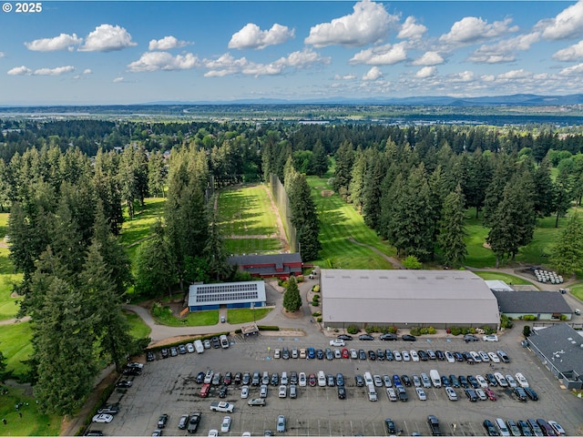birds eye view of property featuring a forest view