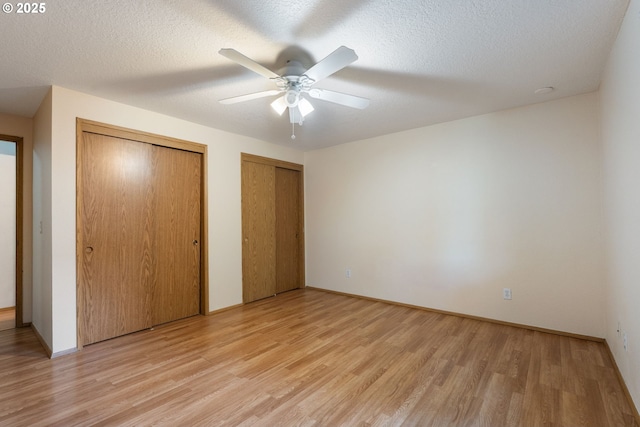 1502 NE 72nd St, Vancouver, WA 98665 - unfurnished bedroom with light wood-type flooring, two closets, and a ceiling fan