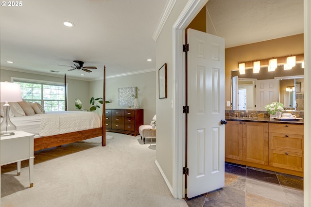 carpeted bedroom with crown molding, baseboards, recessed lighting, and connected bathroom