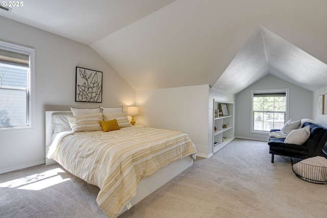 bedroom with baseboards, vaulted ceiling, and carpet