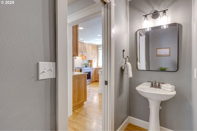 bathroom featuring recessed lighting and wood finished floors