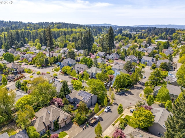 birds eye view of property with a wooded view and a residential view