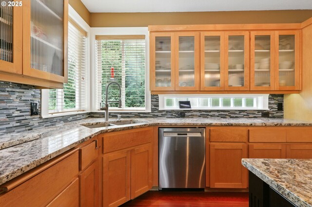20817 NE 101st Ct, Battle Ground, WA 98604 - kitchen with stainless steel dishwasher, backsplash, glass insert cabinets, and light stone counters