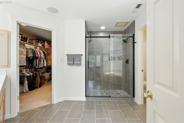 20817 NE 101st Ct, Battle Ground, WA 98604 - bathroom featuring a stall shower, a spacious closet, and tile patterned flooring