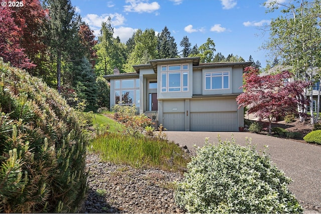 17514 Brookhurst Dr, Lake Oswego, OR 97034 - prairie-style house with an attached garage, asphalt driveway, and stucco siding