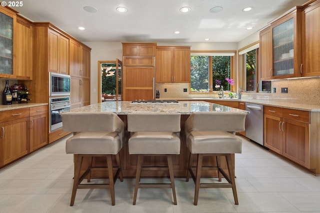 17514 Brookhurst Dr, Lake Oswego, OR 97034 - kitchen featuring built in appliances, backsplash, a center island, light stone countertops, and recessed lighting