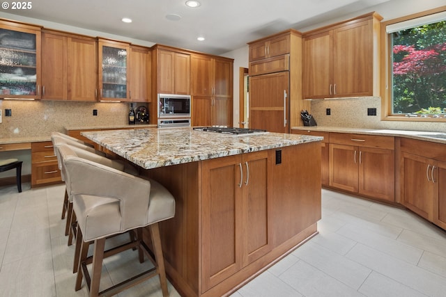 17514 Brookhurst Dr, Lake Oswego, OR 97034 - kitchen featuring built in appliances, recessed lighting, a center island, brown cabinetry, and tasteful backsplash