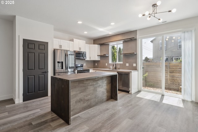 5958 SE 16th Loop, Gresham, OR 97080 - kitchen with stainless steel appliances, open shelves, a chandelier, a center island, and white cabinets