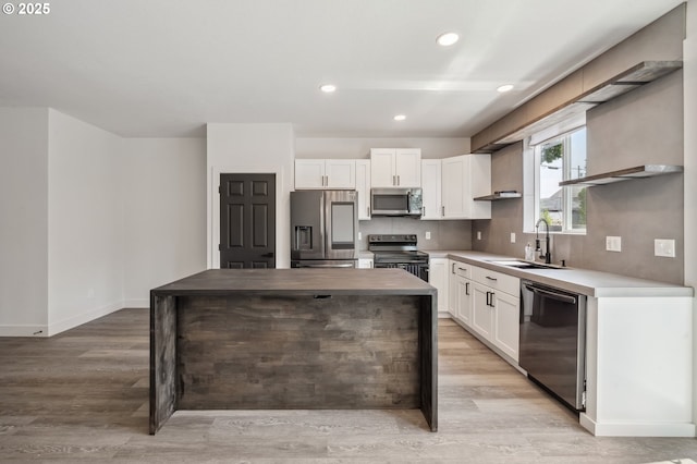 5958 SE 16th Loop, Gresham, OR 97080 - kitchen with appliances with stainless steel finishes, a sink, a kitchen island, open shelves, and white cabinetry