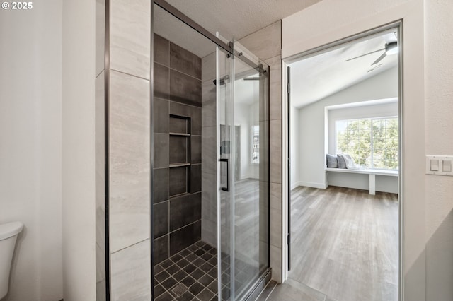 5958 SE 16th Loop, Gresham, OR 97080 - bathroom featuring lofted ceiling, toilet, a shower stall, wood finished floors, and a ceiling fan