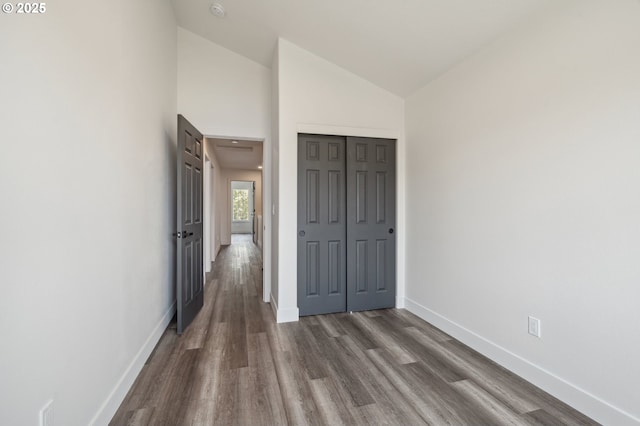 5958 SE 16th Loop, Gresham, OR 97080 - unfurnished bedroom featuring baseboards, dark wood-style flooring, a closet, and vaulted ceiling