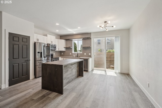 5958 SE 16th Loop, Gresham, OR 97080 - kitchen with stainless steel appliances, open shelves, a kitchen island, light wood-style floors, and recessed lighting