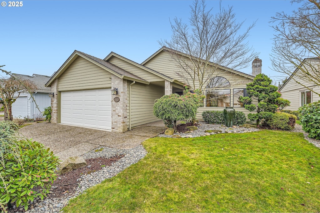 view of front of house with a garage and a front yard