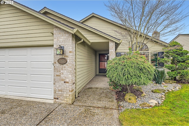 doorway to property with a garage