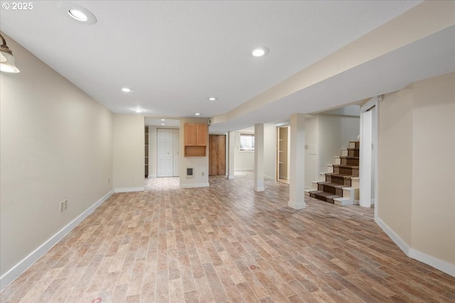 unfurnished living room with stairs, recessed lighting, baseboards, and light wood-type flooring