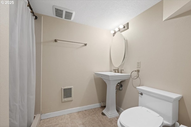 full bathroom featuring tile patterned floors, baseboards, toilet, and visible vents