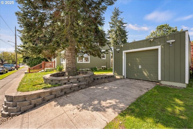 view of front facade with a garage, an outbuilding, board and batten siding, and driveway