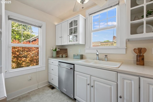 kitchen featuring a sink, white cabinetry, dishwasher, and light countertops