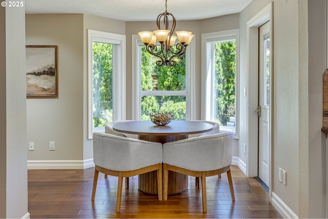 17865 NW Elk Meadow Ln, Portland, OR 97229 - dining area featuring a chandelier, dark wood-style flooring, and baseboards