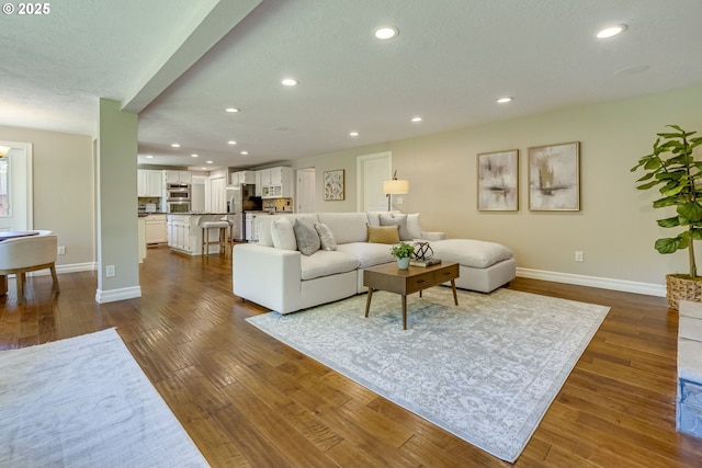 17865 NW Elk Meadow Ln, Portland, OR 97229 - living area featuring baseboards, dark wood-style flooring, and recessed lighting
