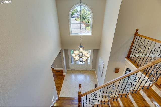17865 NW Elk Meadow Ln, Portland, OR 97229 - entryway with a chandelier, baseboards, a high ceiling, stairs, and wood finished floors