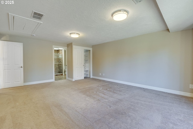 17865 NW Elk Meadow Ln, Portland, OR 97229 - unfurnished bedroom featuring attic access, carpet floors, baseboards, and a textured ceiling