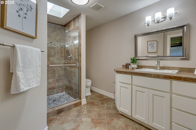 17865 NW Elk Meadow Ln, Portland, OR 97229 - full bathroom with a skylight, vanity, a shower stall, toilet, and baseboards