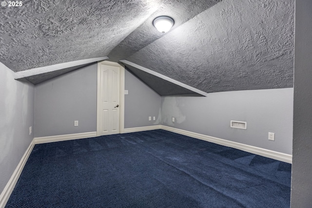 17865 NW Elk Meadow Ln, Portland, OR 97229 - bonus room with a textured ceiling, baseboards, vaulted ceiling, and carpet floors
