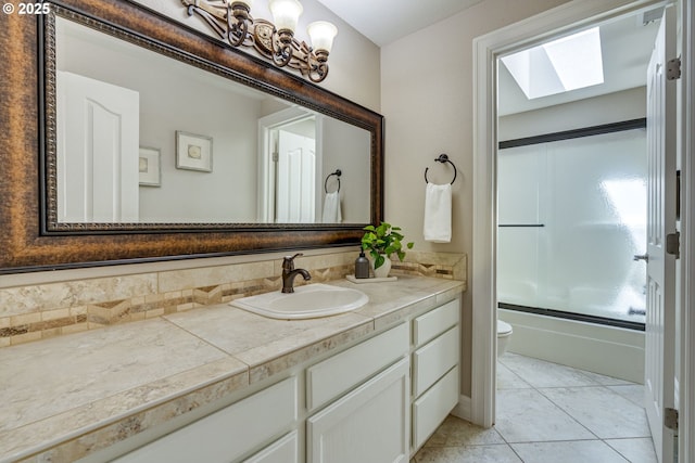 17865 NW Elk Meadow Ln, Portland, OR 97229 - full bath with a skylight, toilet, vanity, combined bath / shower with glass door, and tile patterned floors