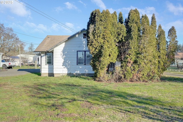 view of property exterior with a yard